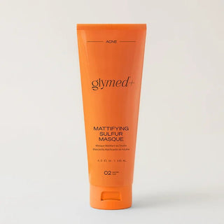 Orange tube of Glymed Mattifying Sulfur Masque on a light gray background