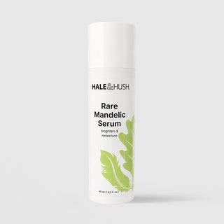 Hale & Hush Rare Mandelic Serum brighten and retexture facial serum in a white airless pump bottle with cap on and green leaf botanical design, 48ml / 1.62 fl oz, on a light gray background