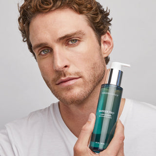 Model holding Colorescience Barrier Pro 1-Step Cleanser teal pump bottle