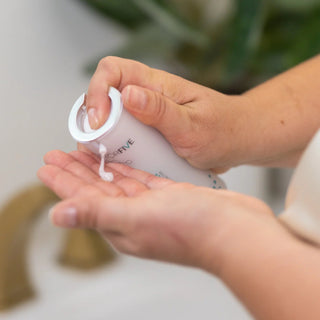 Woman dispensing FactorFive Nourishing Silk serum from bottle into palm
