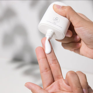 Pfect-a Solar Elixir sunscreen being dispensed onto hands
