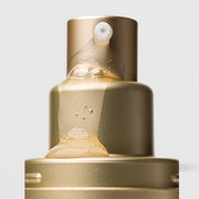 Close-up of Plated Skin Science INTENSE Serum pump nozzle dispensing lightweight golden serum with micro-bubbles