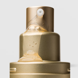 Close-up of Plated Skin Science INTENSE Serum pump nozzle dispensing lightweight golden serum with micro-bubbles
