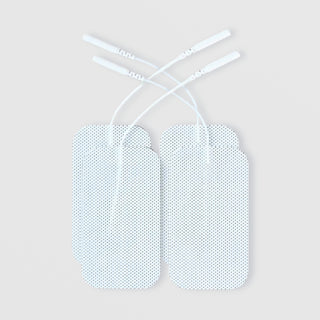 Four white rectangular electrode pads with textured surfaces and white lead wire connectors, displayed against a light gray background.