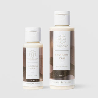 Rhonda Allison Pigmentation Solutions Brightening Scrub polish and glow exfoliating facial scrub shown in both 60mL and 120mL flip-cap bottle sizes