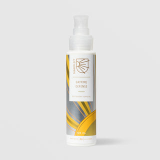 Rhonda Allison Sun Reflect Daytime Defense Outdoor Topical 120 mL in a white pump bottle with gold and gray sun ray patterned label on a light gray background