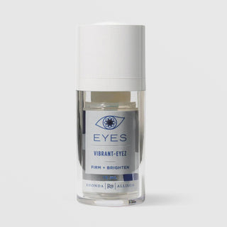 Rhonda Allison Eyes Vibrant-Eyez Firm and Brighten eye cream in a 15mL clear airless pump bottle with white cap and silver and navy blue label on a light gray background