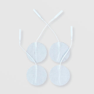 Four light blue round electrode pads with textured surfaces and white lead wire connectors, displayed against a light gray background.