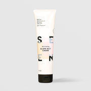 SEEN Skin-Caring Blow-Out Creme (5 fl oz) in a white squeeze tube with a black cap and bold SEEN lettering accented by soft peach, pink, and blue color blocks, labeled dermatologist designed and non-comedogenic, displayed against a light gray background.
