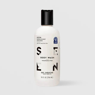 SEEN Fragrance Free Body Wash (10 fl oz / 296 ml) in a white bottle with black flip cap and bold black SEEN lettering, labeled dermatologist developed and safe for sensitive skin, with a National Eczema Association accepted seal, displayed against a light gray background.