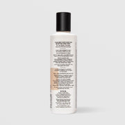 Back of SEEN Scented Conditioner bottle showing usage instructions, ingredient claims, and bilingual English and French text, against a light gray background.