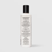 Back of SEEN Fragrance Free Conditioner bottle showing usage instructions, ingredient claims, and bilingual English and French text, against a light gray background