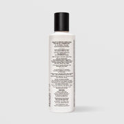 Back of SEEN Fragrance Free Shampoo bottle showing usage instructions, ingredient claims, and bilingual English and French text, against a light gray background.