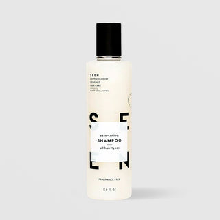 SEEN Fragrance Free Skin-Caring Shampoo (8.6 fl oz) in a white bottle with black flip cap and bold black SEEN lettering, labeled dermatologist designed, non-comedogenic, and suitable for all hair types, displayed against a light gray background.