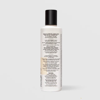 Back of SEEN Scented Shampoo bottle showing usage instructions, ingredient claims, and bilingual English and French text, against a light gray background.