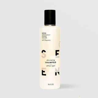 SEEN Skin-Caring Shampoo (8.6 fl oz) in a white bottle with black flip cap and bold black SEEN lettering, labeled dermatologist designed, non-comedogenic, and suitable for all hair types, displayed against a light gray background.
