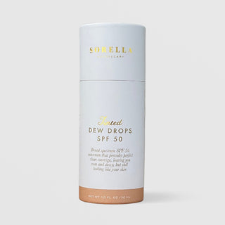 Sorella Apothecary Tinted Dew Drops SPF 50 1 fl oz in a white cylindrical box with light tan tint shade indicator on a light gray background