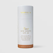 Sorella Apothecary Tinted Dew Drops SPF 50 1 fl oz in a white cylindrical box with medium tan tint shade indicator on a light gray background