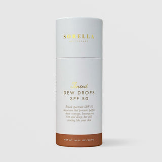 Sorella Apothecary Tinted Dew Drops SPF 50 1 fl oz in a white cylindrical box with deep tan tint shade indicator on a light gray background